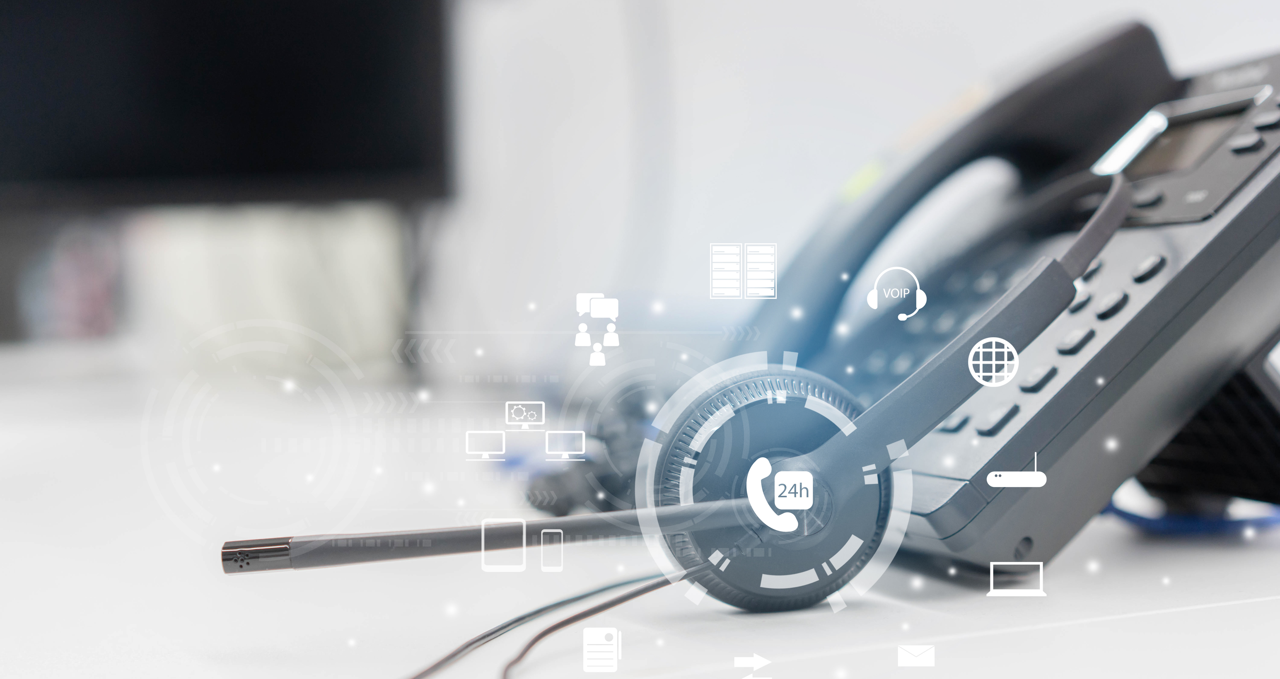close up headset of call center and voip communication with futuristic virtual icon telecommunication technology on office table in monitoring room for network operation job concept